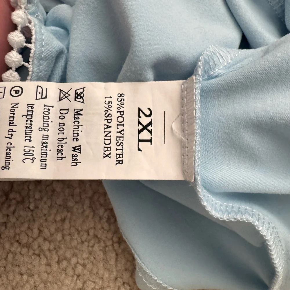 Sky Blue Ruffled Kids Blouse fits like a woman’s small